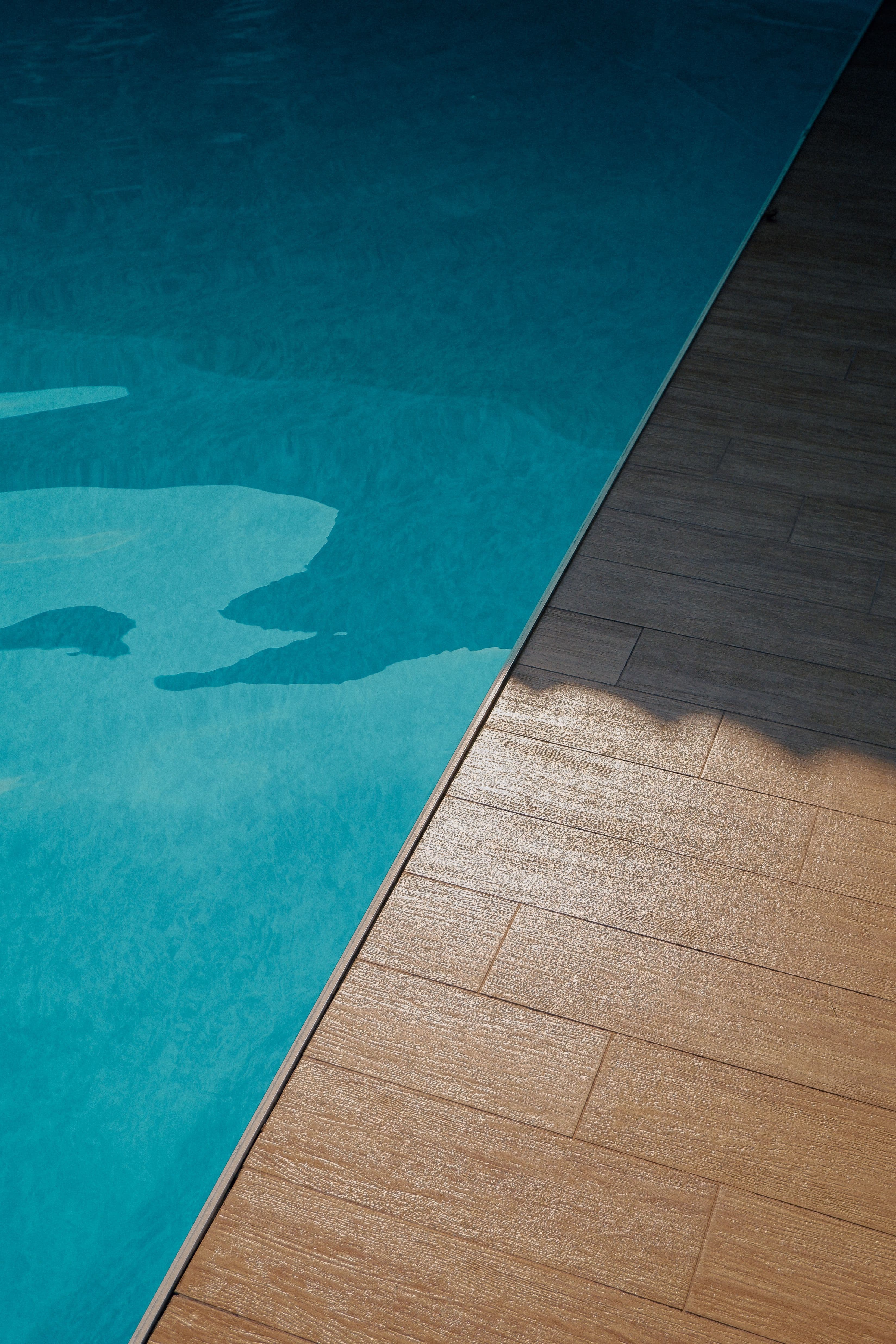 Sunlit poolside deck kept in good condition through regular maintenance